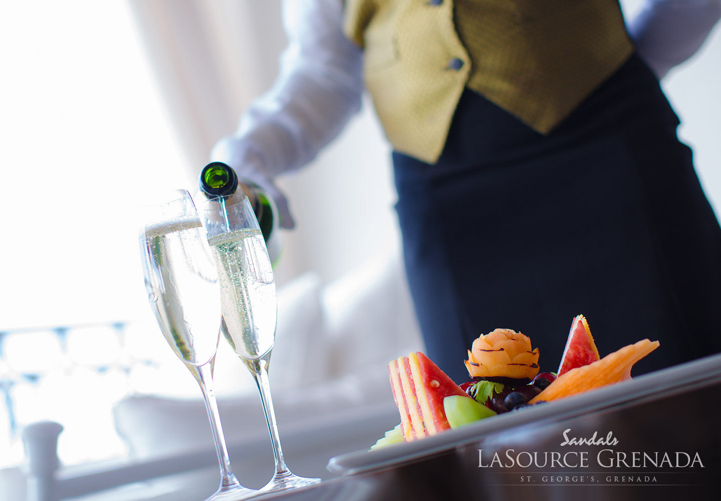 Sandals butler pouring champagne