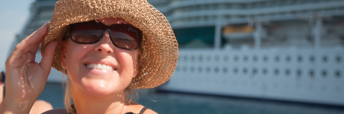 Woman on Tender Boat with Cruise Ship in the Background / By Feverpitch, Deposit Photos