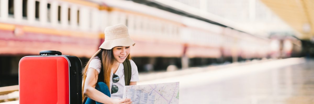 Girl with red suitcase at train station by beer5070, Deposit Photos