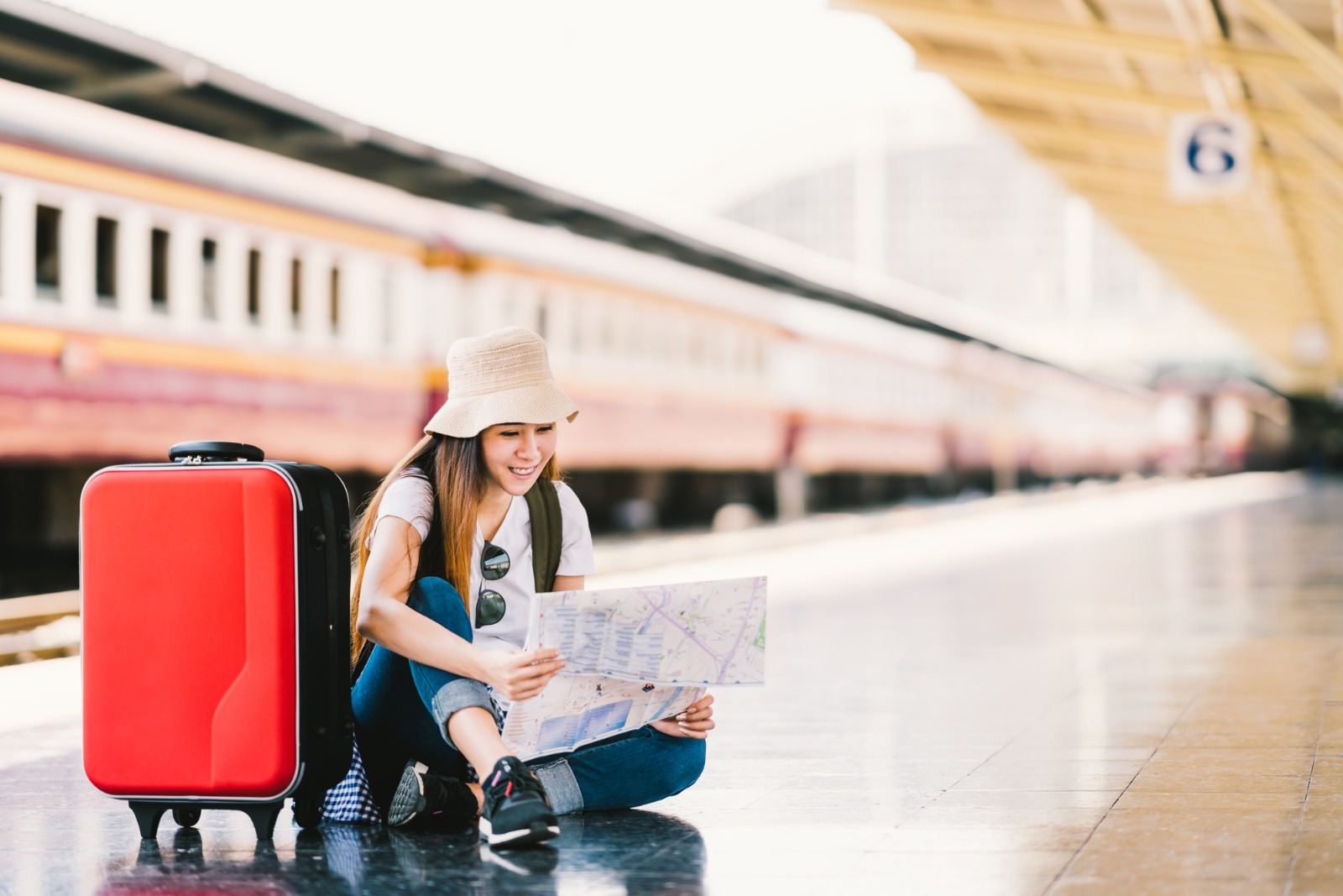 Girl with red suitcase at train station by beer5070, Deposit Photos