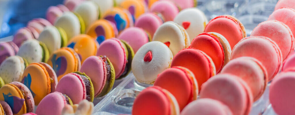 Colorful macarons for sale on counter of a bakery