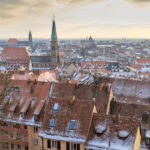 Snow-dusted buildings in Nuremberg during the holidays. Image by Bertl123