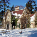 Washington Irving's Sunnyside cottage with snow on a sunny day.