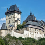 Karlstejn Castle in the Czech Republic with blue sky by VrabelPeter1